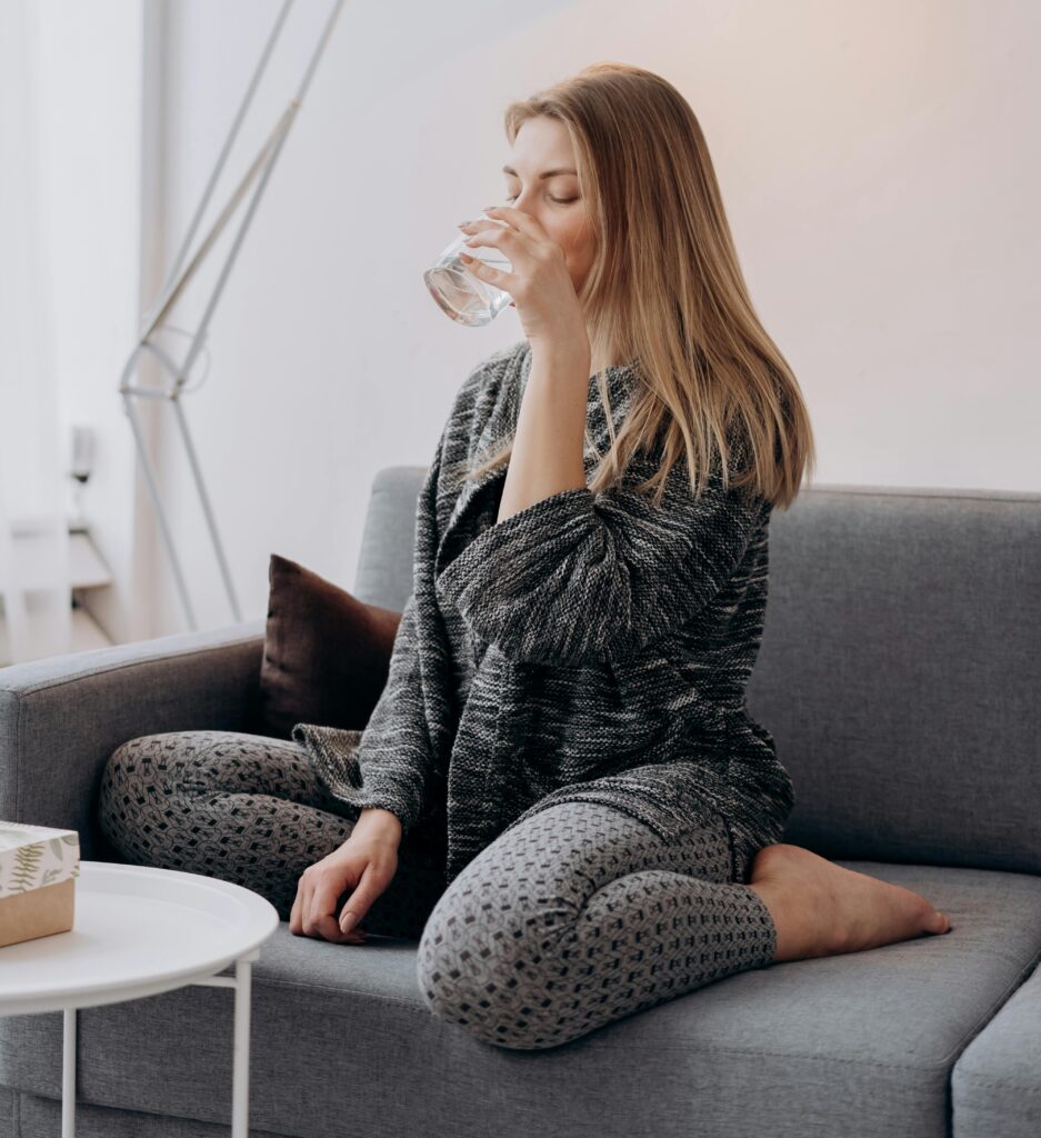 If You Want To Look Younger, Start Fixing These 15 Habits First woman drinking water daily habit to look younger and get clear skin