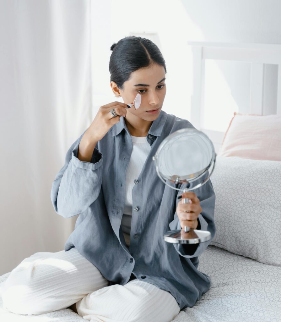 If You Want To Look Younger, Start Fixing These 15 Habits First woman using jade roller for younger looking skin